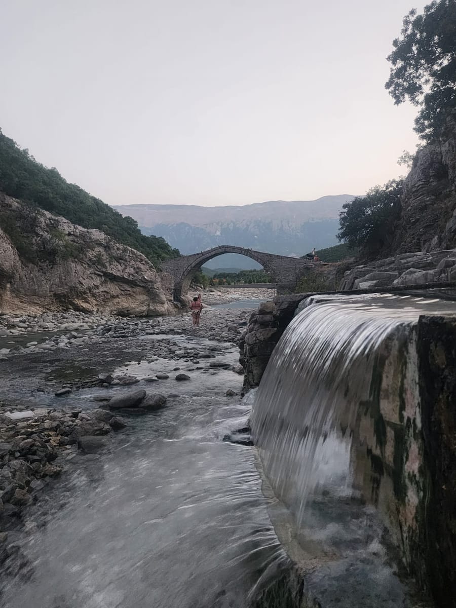 The Kadiu Bridge and a small waterfall at the Benja springs