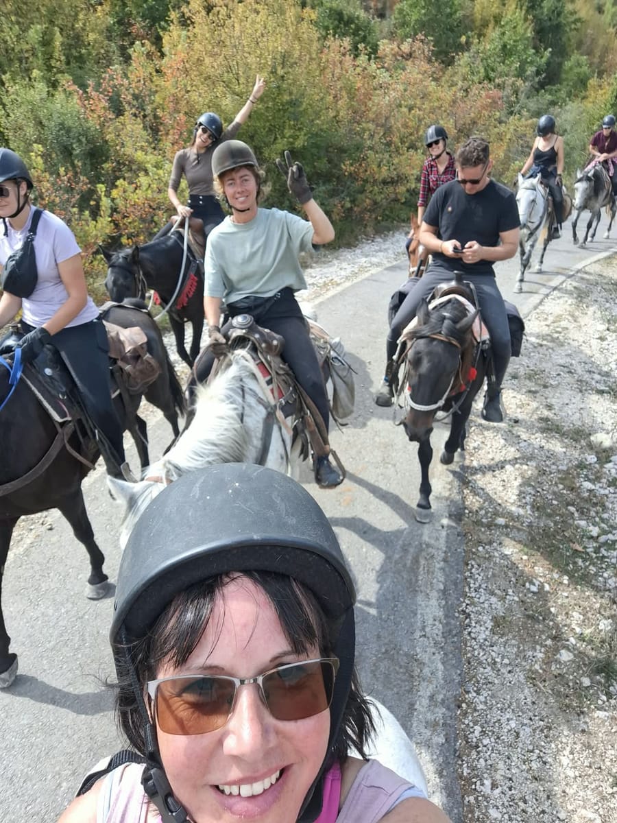 Rider’s view of the group riding along a village road in Albania