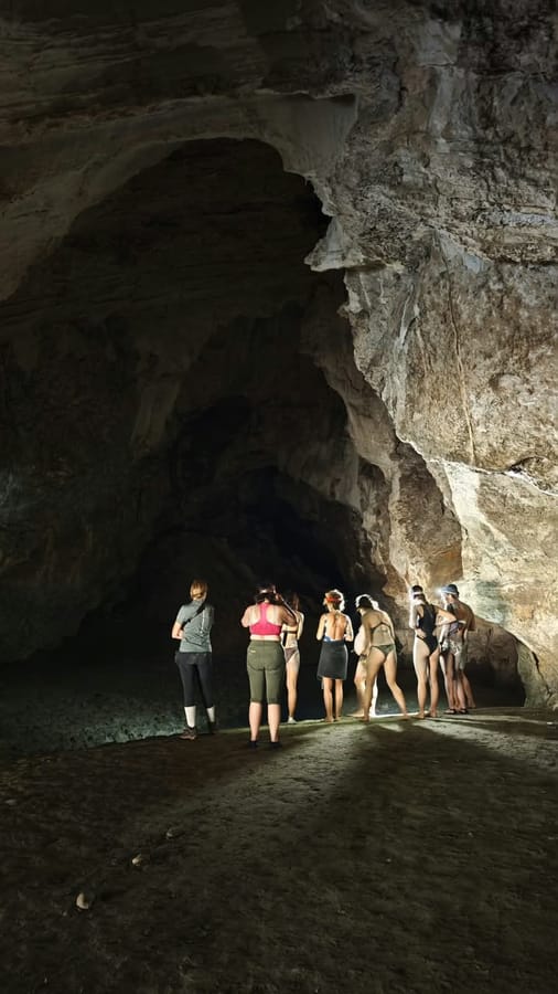 A group of riders inside a large cave